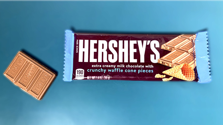Piece of Hershey's waffle cone chocolate bar in next to packaged bar