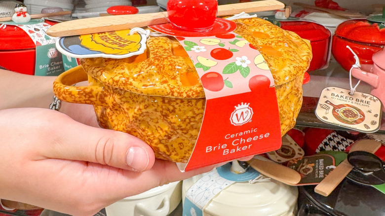 Hands holding Apple pie Brie cheese baker in HomeGoods