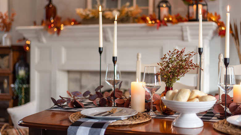 Place settings and candles on Thanksgiving table