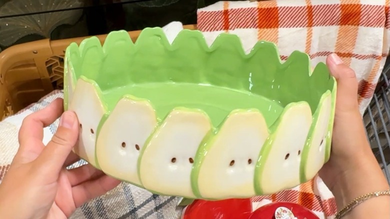 Hands holding pear-themed pie dish in HomeGoods