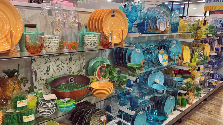 Shelves of colorful dining and serve ware in HomeGoods store