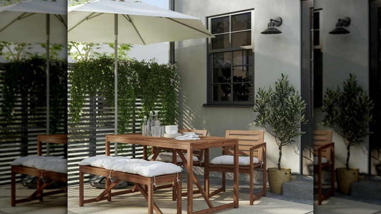 NAMMARO four person table set under umbrella outside