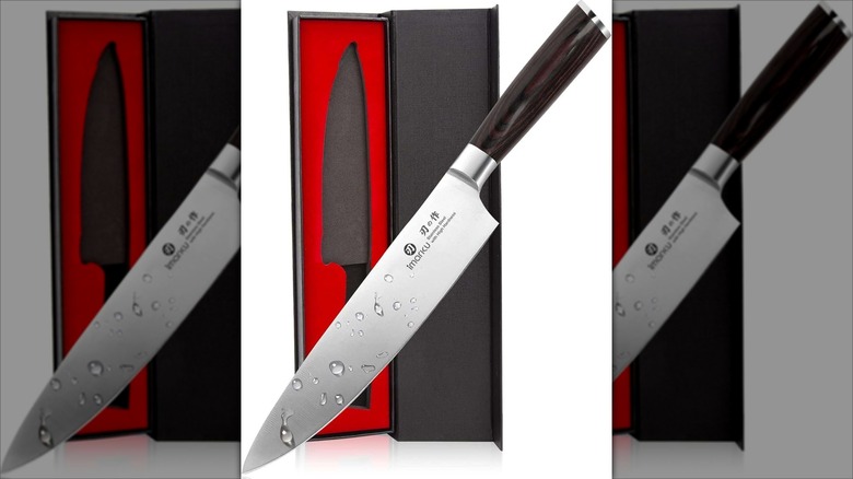 imarku gyuto knife with a black handle and red and black packaging against a white background.