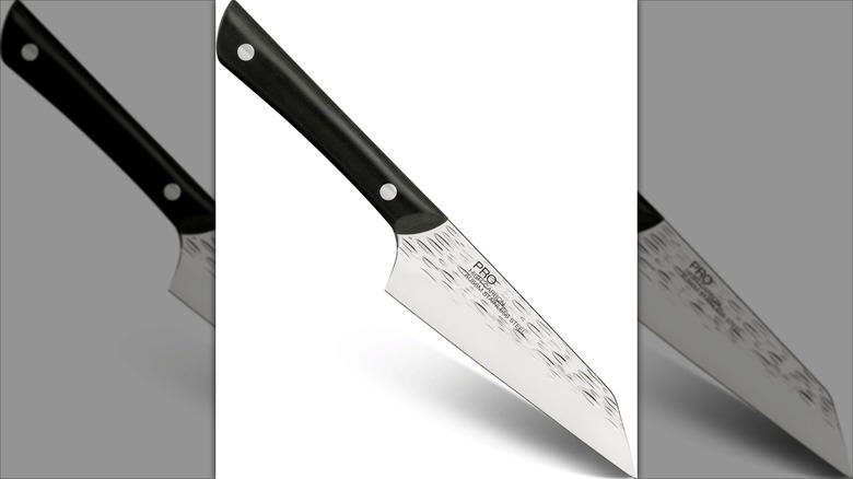 Kai Japanese boning knife with a black handle against a white background.