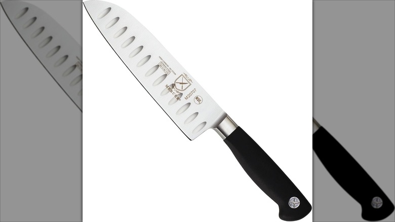 Mercer Culinary Genesis santoku knife with black handle against a white background.