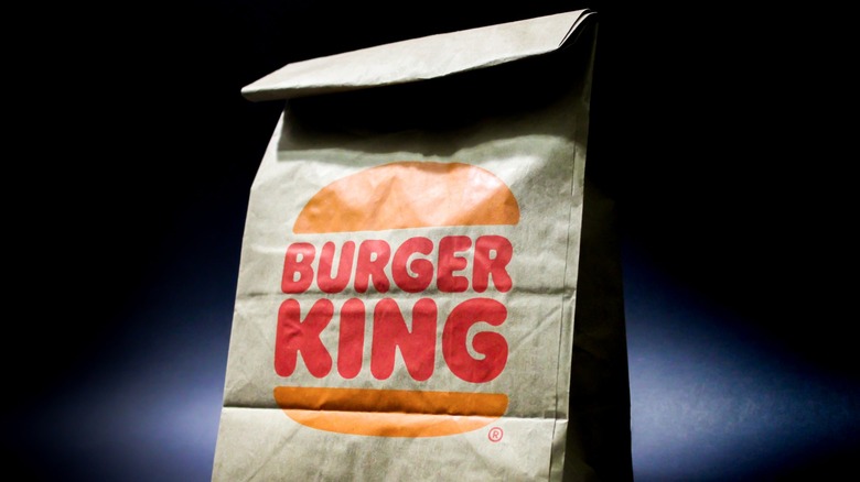 A tray with a burger, fries, and beverage from Burger King