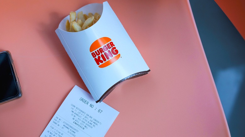 Burger King's burger, nuggets, fries, and beverage on a table