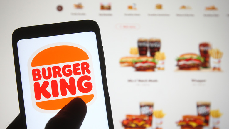 Person using Burger King app and website