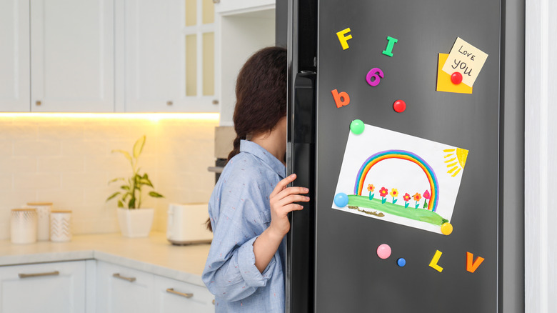 Person opening refrigerator door