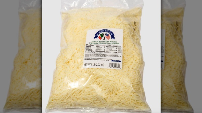 Bag of shredded mozzarella on white background