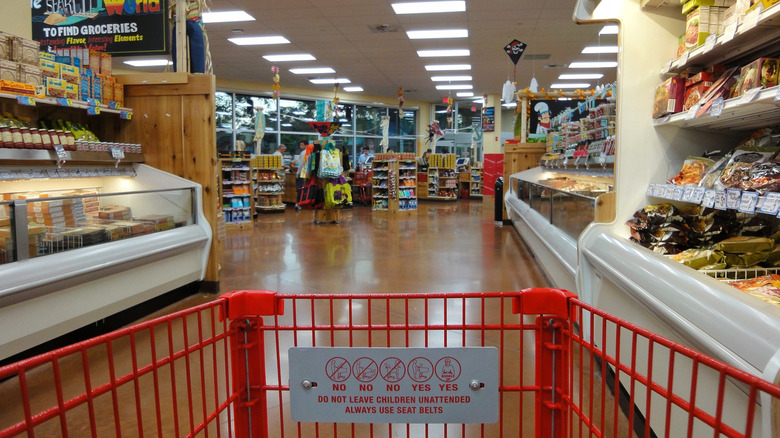 View behind a shopping cart in a Trader Joe's aisle