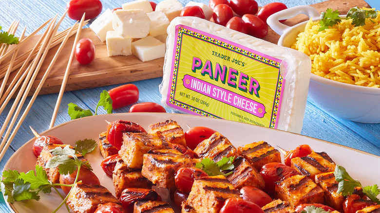 Paneer block next to raw and grilled paneer cubes