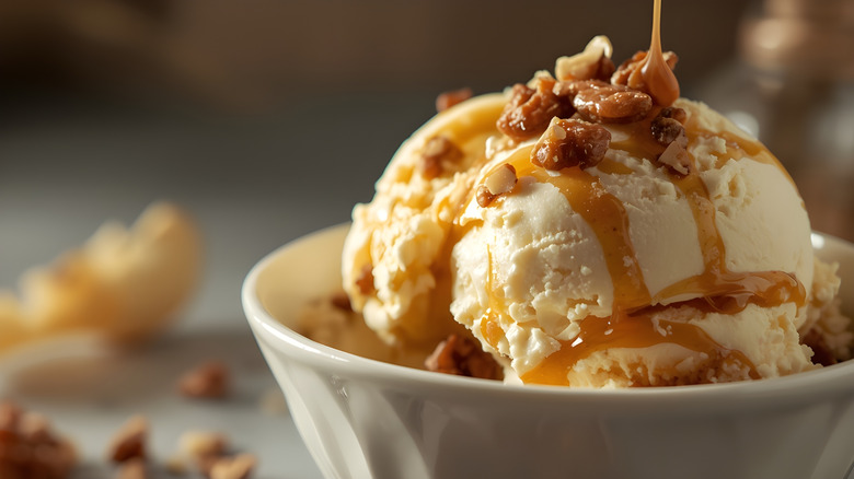 Close-up on a bowl of praline ice cream with caramel drizzled on top