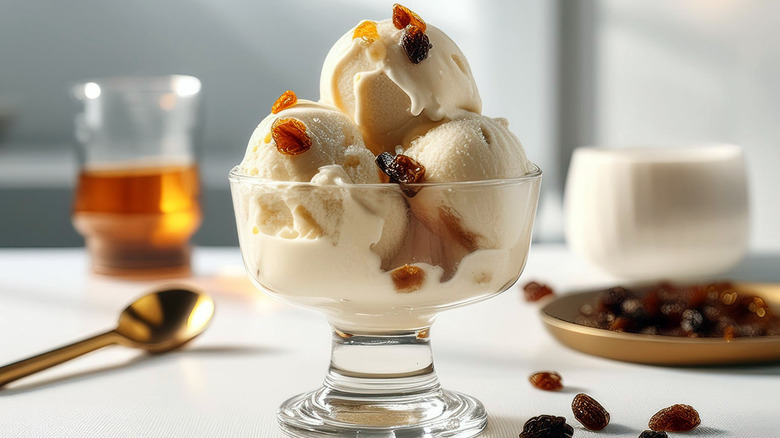 A glass coupe of rum raisin ice cream on a tabletop