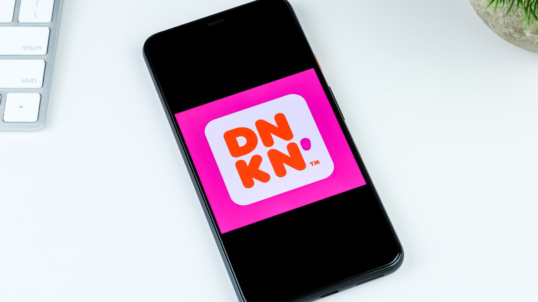 The Dunkin' app logo is displayed on a smartphone