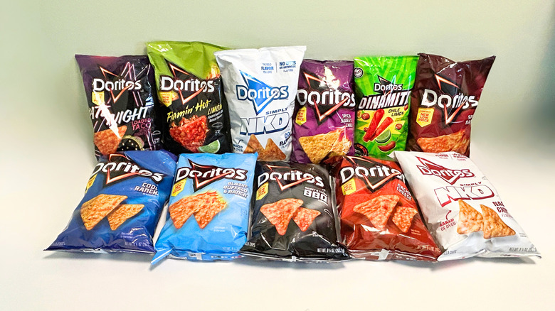 Eleven bags of Doritos arranged together in two rows