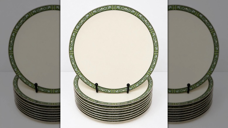 A plate with the Lenox Adrienne pattern on top of a stack of other Arienne-patterned plates