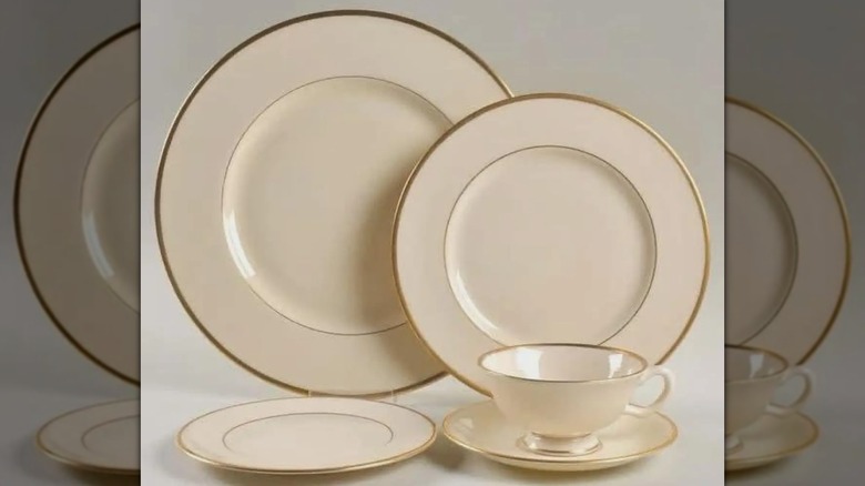 A set of four plates and a teacup with the Lenox Mansfield pattern