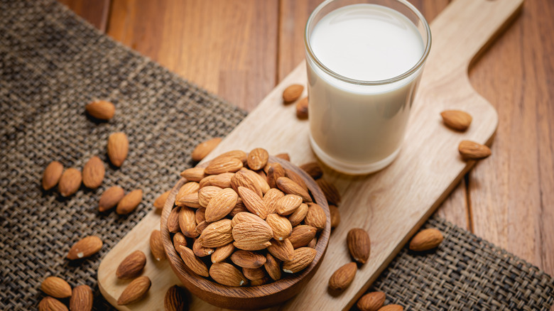 almond milk and almonds in bowl