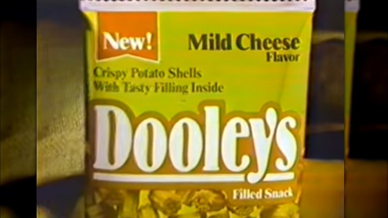 A still from a Dooley's Filled Snacks ad depicting a green bag of snack chips
