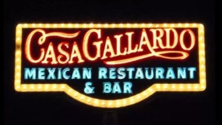 A colorful vintage image of a Casa Gallardo sign against a black background