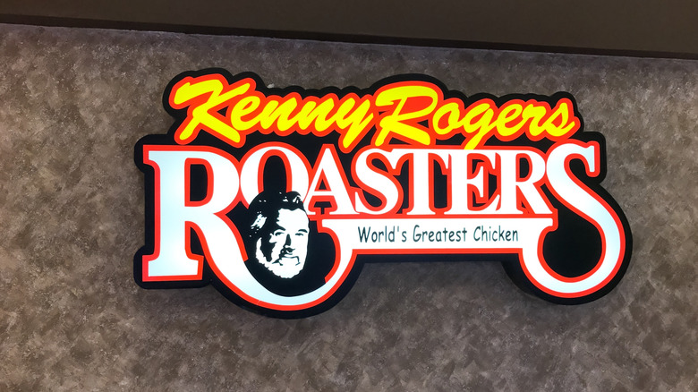 A Kenny Rogers Roasters sign against a mottled grey background