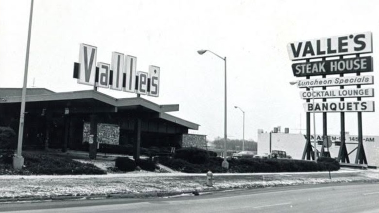 A black-and-white picture of a Valle's Steak House, showing its road sign and restaurant