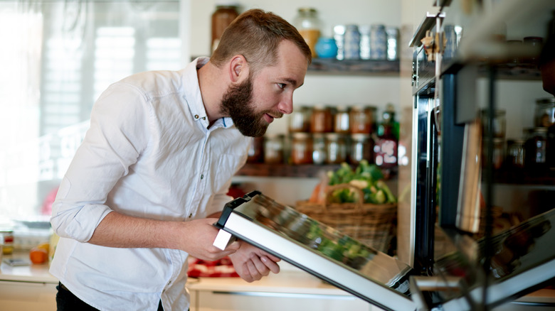 Man looking inside domestic oven