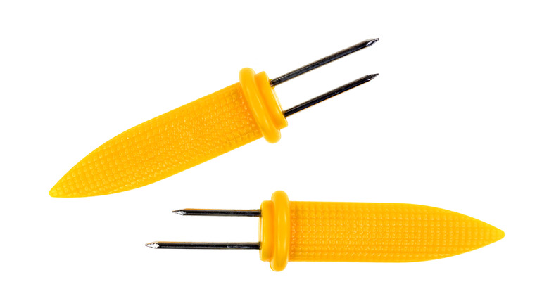 Two corn cob holders shaped like corn