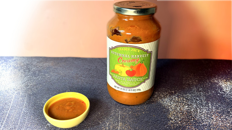 Jar and small bowl of tomato pasta sauce