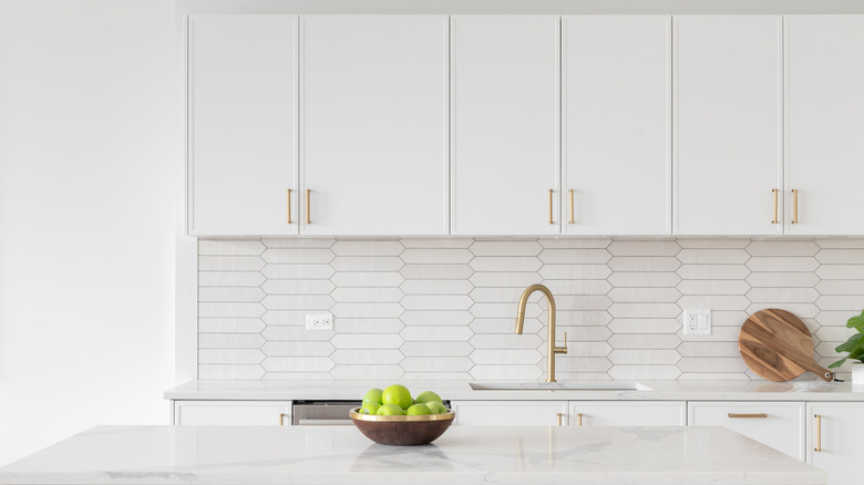 All-white kitchen with gold fixtures