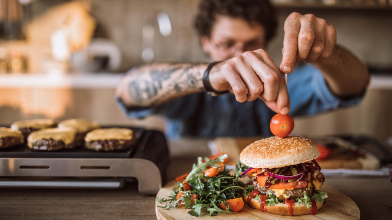 chef decorating burger