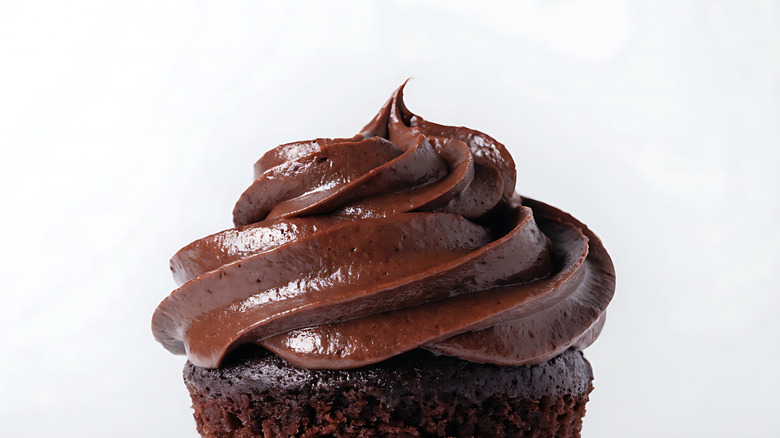 A chocolate cupcake topped with rich chocolate frosting
