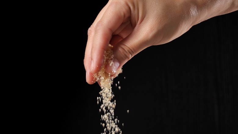 Hand sprinkles sugar