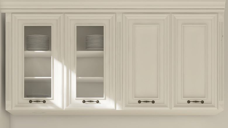 Kitchen upper cabinets with glass and raised-panel doors