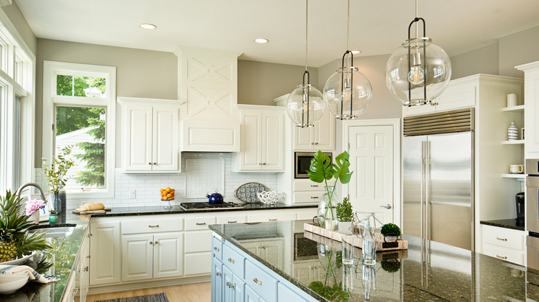 Bright kitchen with recessed and pendant lighting