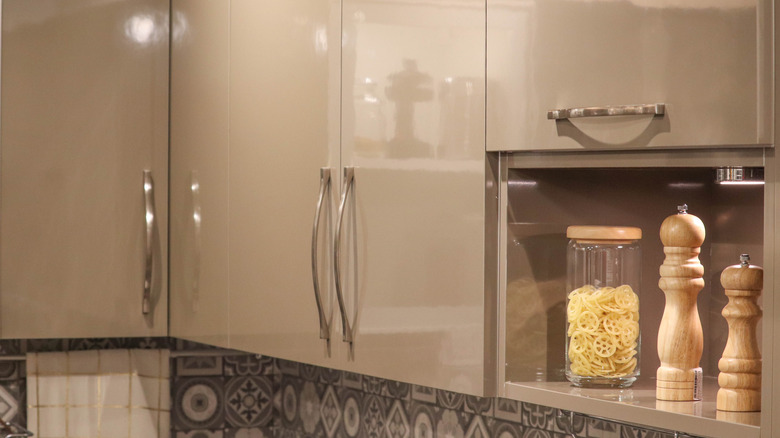 Taupe-colored upper kitchen cabinets with glossy finish