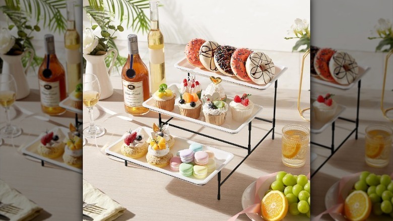 Three tier serving tray on counter with desserts and drinks