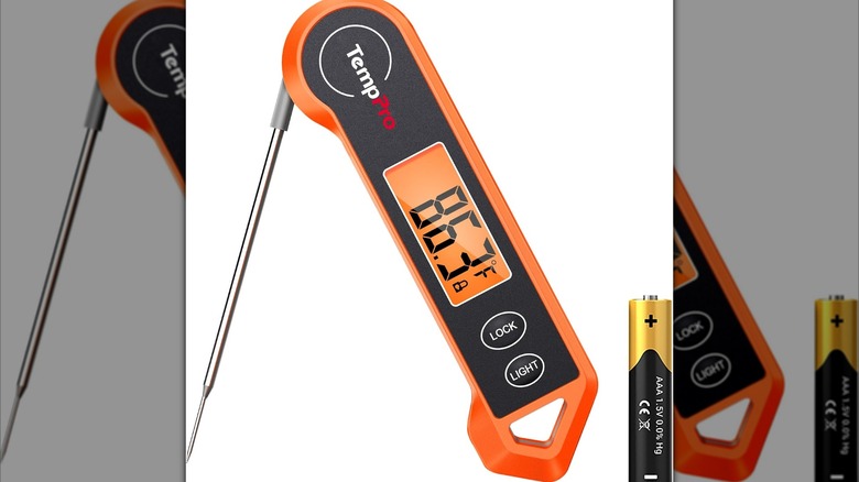 orange digital thermometer and battery