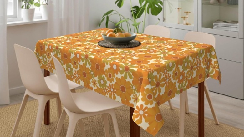 Flowery '70s tablecloth on table with chairs