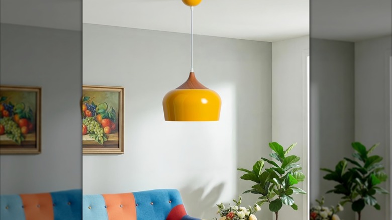 yellow and wood pendant light hanging over colorful sitting area