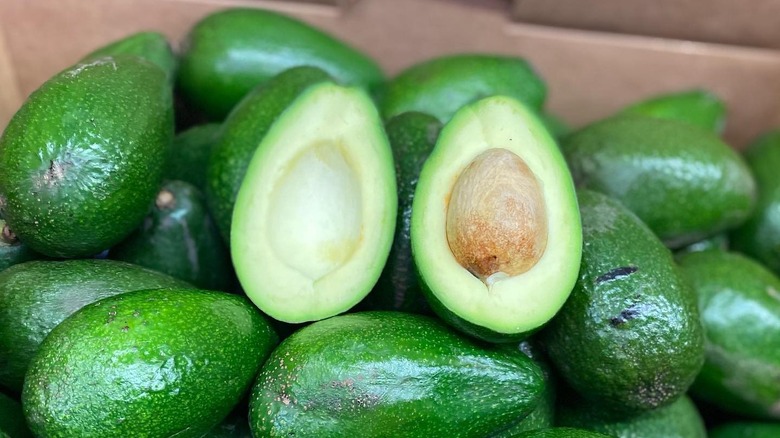 halved bacon avocado sitting on pile