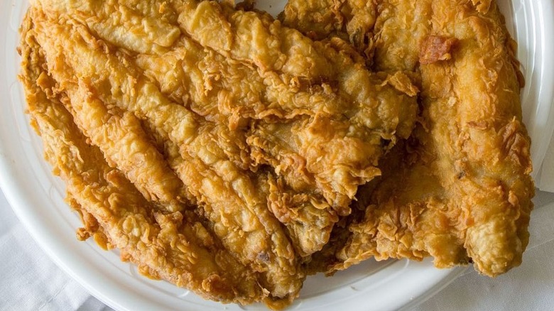 fried lake trout on white plate