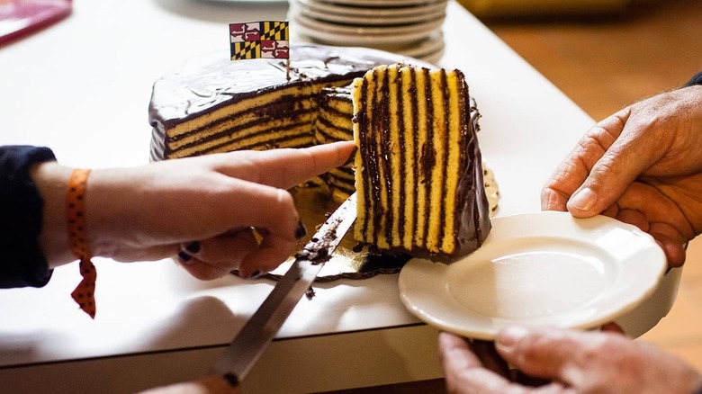 hands slicing Smith Island cake