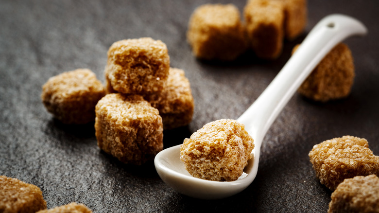 Brown sugar cubes on a small soup spoon