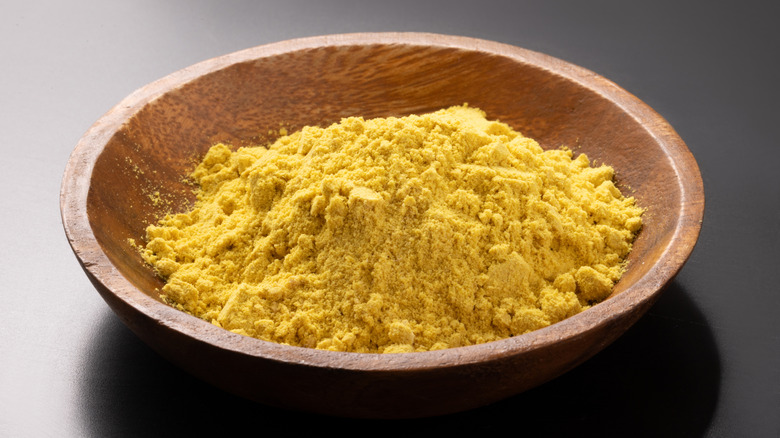 Mustard powder in a small wooden bowl