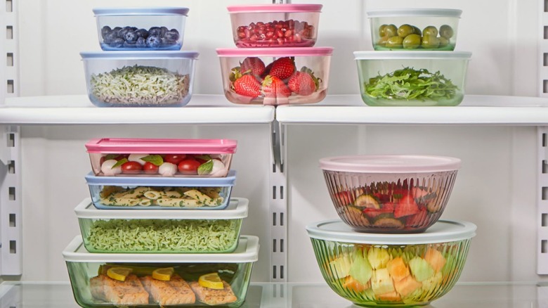 Pyrex Colors mixing bowls and storage containers stacked in a refrigerator