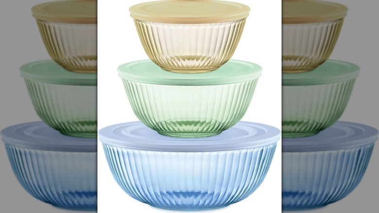 Pyrex Colors sculpted and tinted mixing bowls with lids on a white background