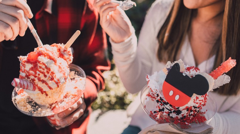 Two people eating Disney-themed ice cream sundaes