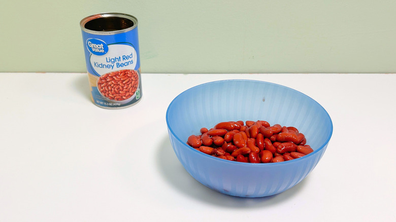 A can of Great Value Light Red Kidney Beans next to a blue bowl of kidney beans